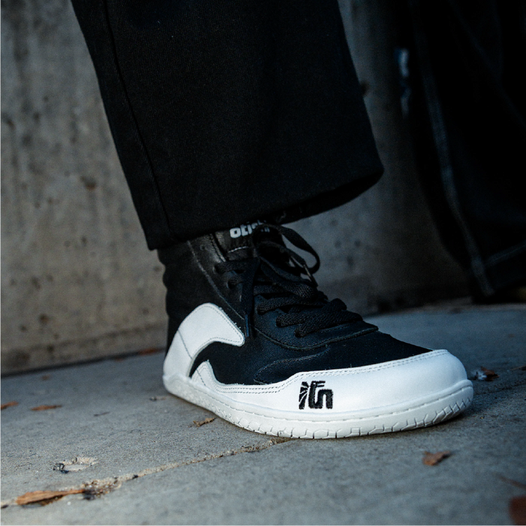 A close view of the textured gum outsole edge and tread of the Otishi S
