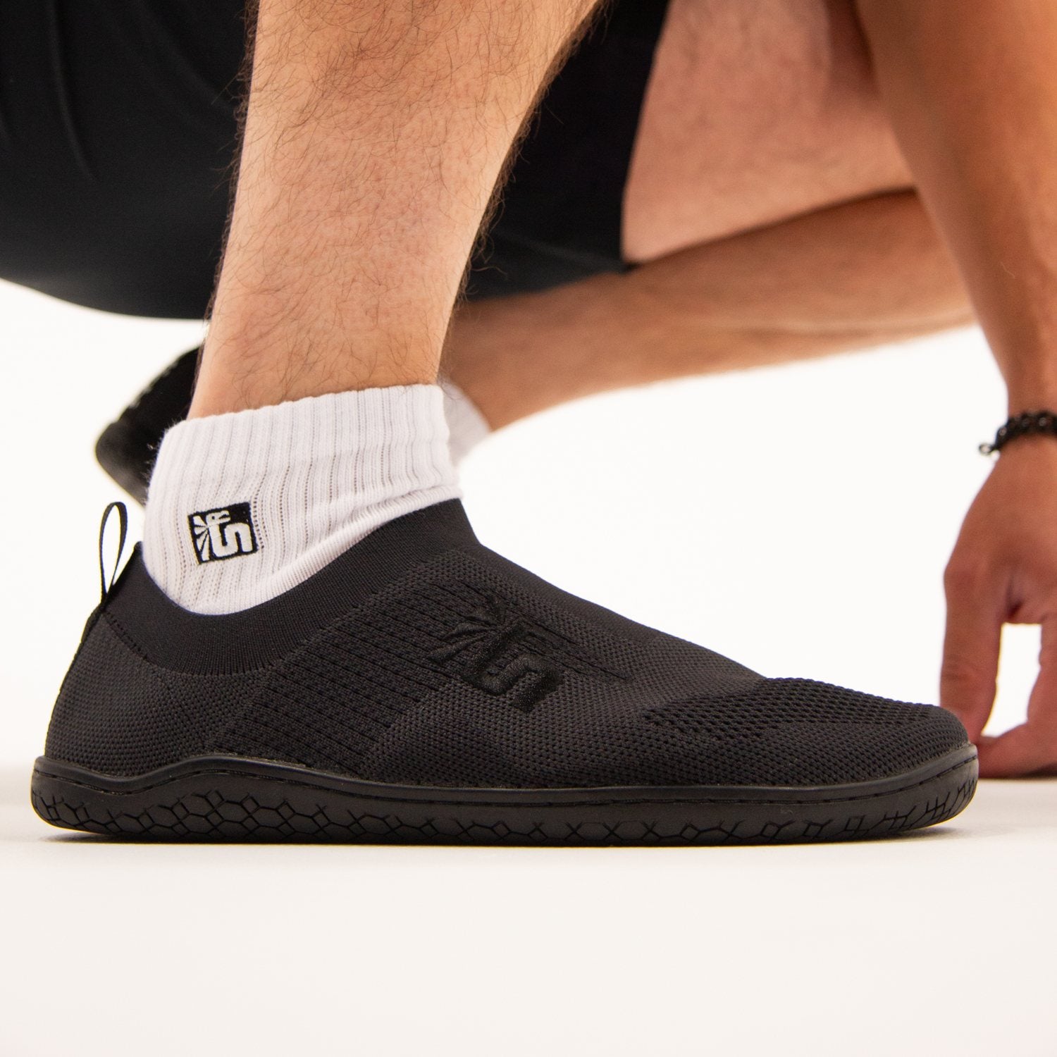 The Otishi 2.0 Low worn on foot, flat sole planted