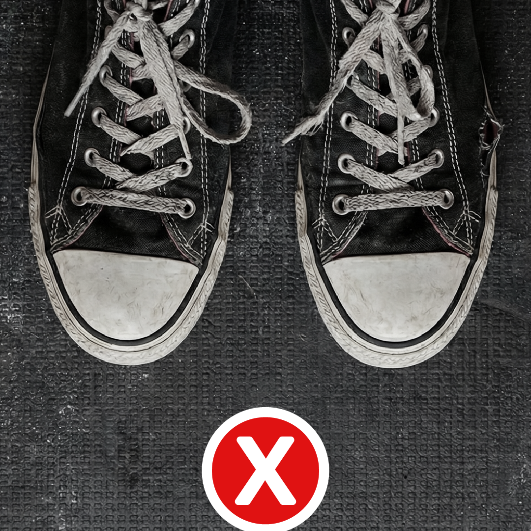 Top-down view of black canvas sneakers with narrow toe boxes